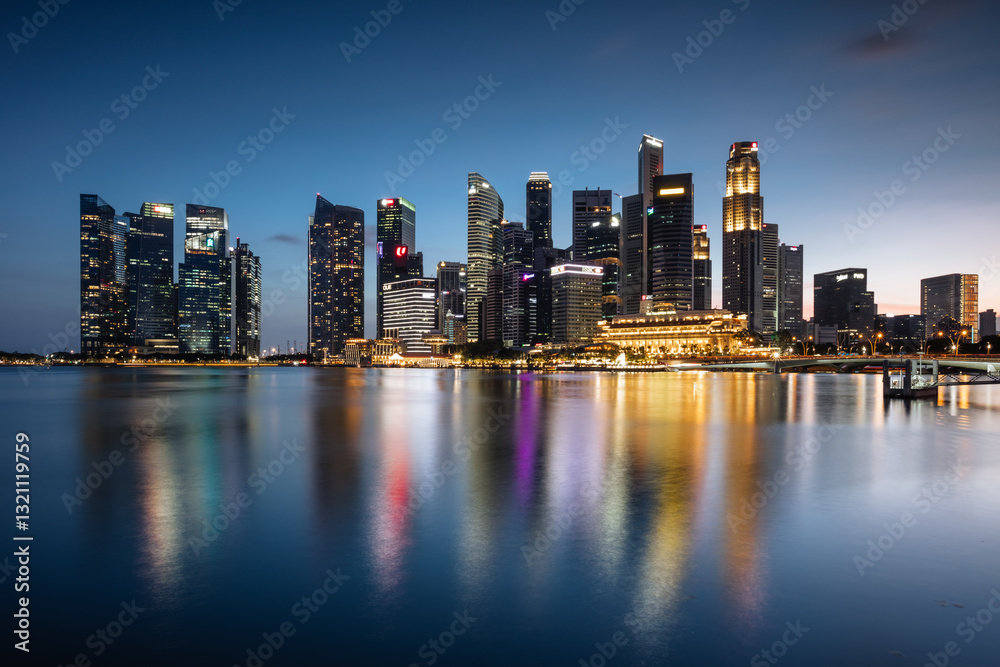 Downtown skyline reflected into water at dusk, Marina Bay, Singapore City Downtown skyline reflected into water at dusk, Marina Bay, Singapore City