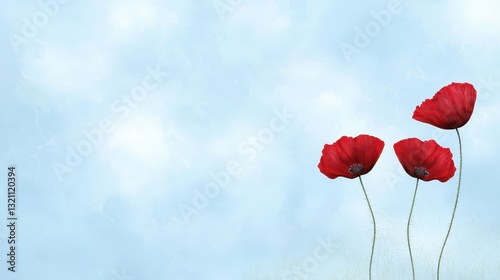 Vibrant red flowers bloom against a clear blue sky, breathtaking natural display of color and beauty