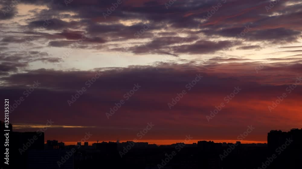 Breathtaking timelapse of clouds moving gracefully over a city at sunrise, painted with soft pink, orange, and golden hues. The dynamic sky contrasts beautifully with the urban landscape, creating a m Breathtaking timelapse of clouds moving gracefully over a city at sunrise, painted with soft pink, orange, and golden hues. The dynamic sky contrasts beautifully with the urban landscape, creating a m
