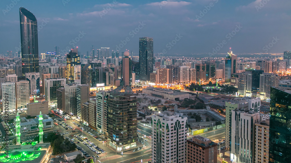 Naklejka premium Modern city architecture of Abu Dhabi skyline day to night timelapse, UAE.