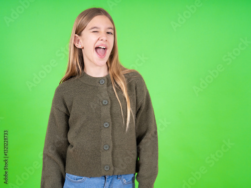 beautiful teen girl wearing green sweater winking looking at the camera with sexy expression, cheerful and happy face.