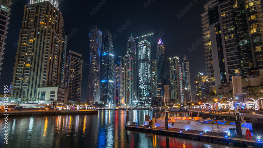 Fototapeta premium Dubai marina bay with yachts an boats night timelapse hyperlapse