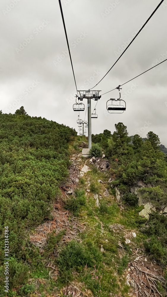 Chairlift ascending mountainside in high tatras, slovakia Chairlift ascending mountainside in high tatras, slovakia