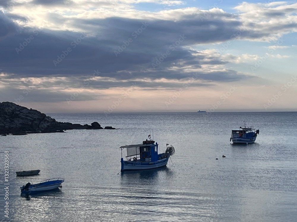 Naklejka premium fishing boats at sunset Porto ferro, Alghero, Italy.