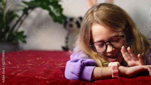 Young girl engaging with her smartwatch, demonstrating user-friendly nature of technology designed for kids. Image highlights functionality, connectivity, and innovation in everyday life.