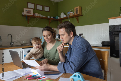 Family Budgeting Together with Laptop and Papers