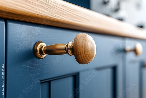 Close-up of a wooden cabinet knob on a blue kitchen cabinet