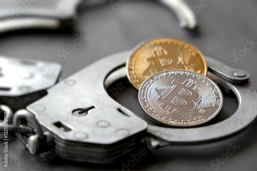 Crime in the financial sector. The concept of bitcoin mining, handcuffs as a symbol of legality. Blockchain technology, cryptocurrency.