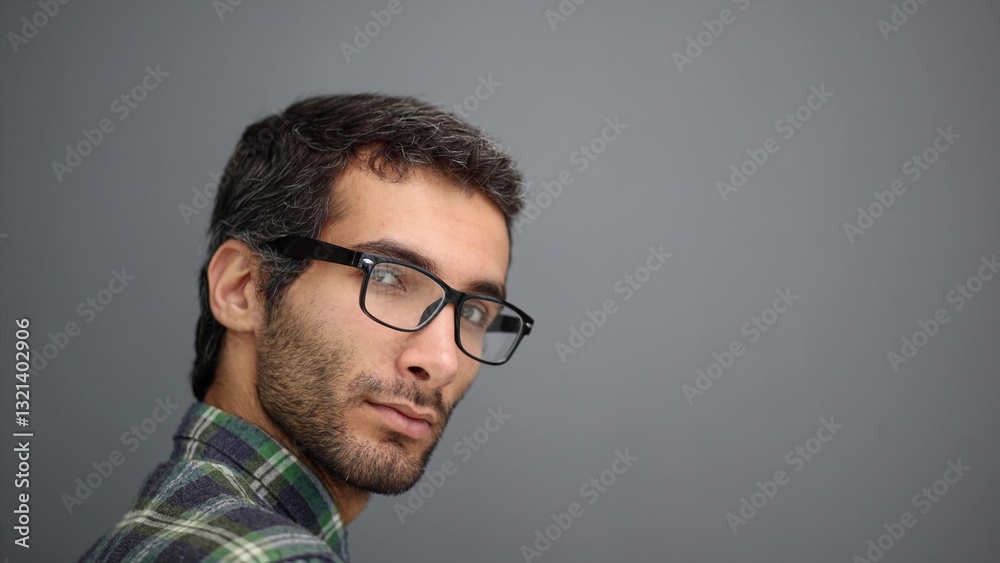 Obraz premium Portrait of a handsome middle aged man posing against a gray background.