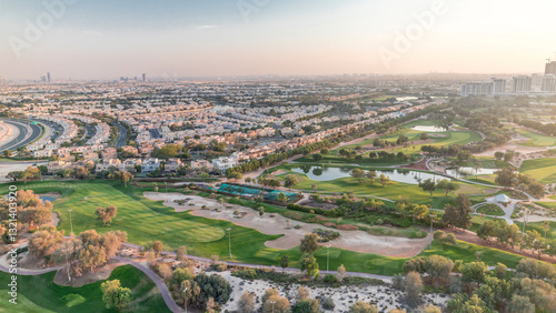 Canvas Print Aerial view to villas and houses with Golf course with green lawn and lakes time