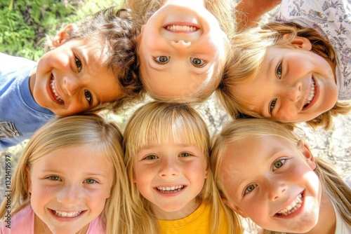 Top-down view of diverse group of six smiling children outdoors in a circle, wearing casual clothes with trees in background