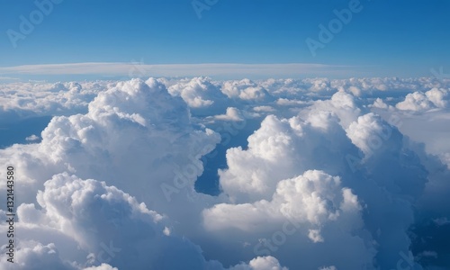 Majestic aerial view of cumulus clouds under a clear blue sky expanse photo