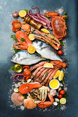 Background filled with fresh fish, lobsters, seafood and shellfish. Vertical photo. Top view.