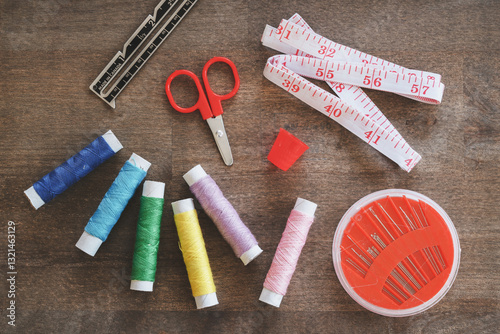 Sewing thread and accessories on rustic wood table