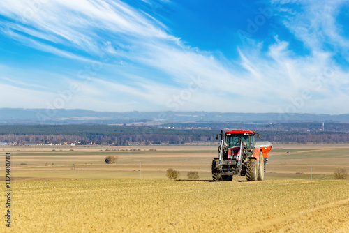 Obraz na płótnie Tractor in a field of the early spring time agricultural activities. w salonie