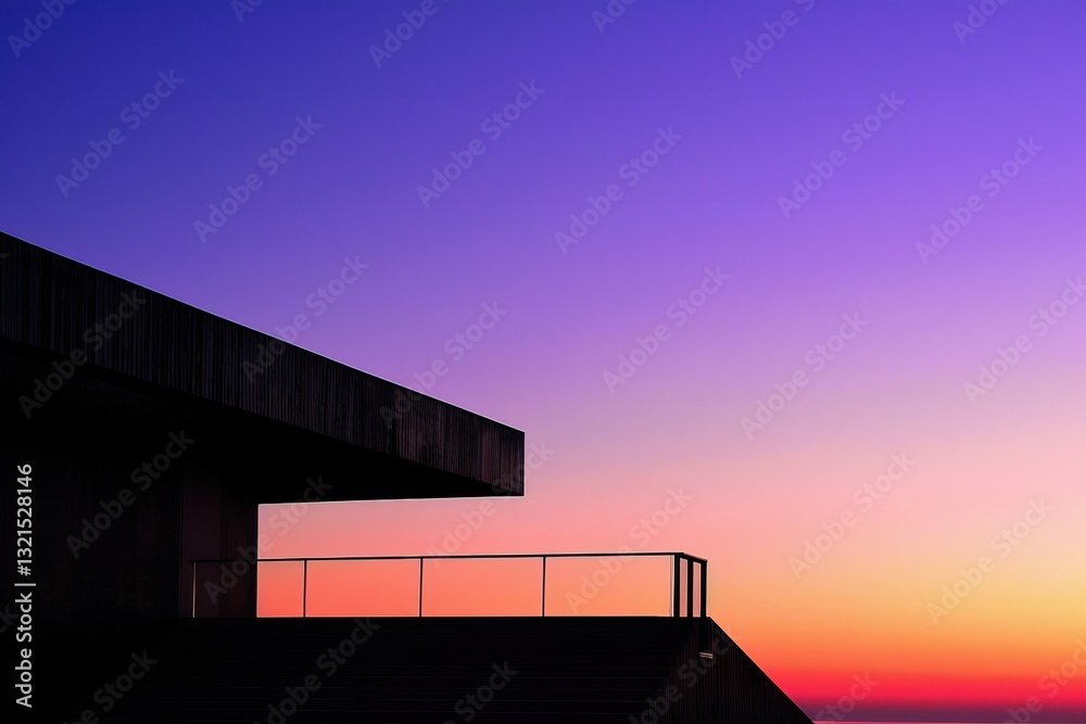 Obraz premium A modern building silhouette against a vibrant sunset backdrop, showcasing a gradient of purples and oranges in the sky.