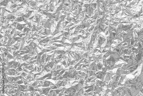 Shiny silver foil texture background, pattern of wrapping paper with crumpled and wavy.