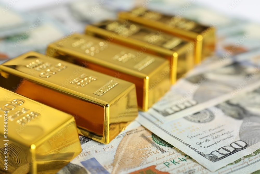 Shiny gold bars on dollar banknotes, closeup. Space for text Shiny gold bars on dollar banknotes, closeup. Space for text