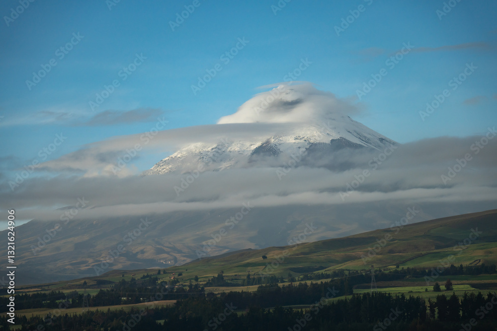 Clouds blowing over the glacier covered peak of Cotopaxi Volcano, seen from a nearby lodge, Ecuador Clouds blowing over the glacier covered peak of Cotopaxi Volcano, seen from a nearby lodge, Ecuador