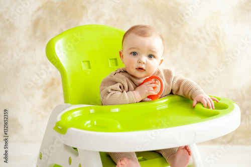 a baby in a green high chair eats, baby food concept, place and space for text photo