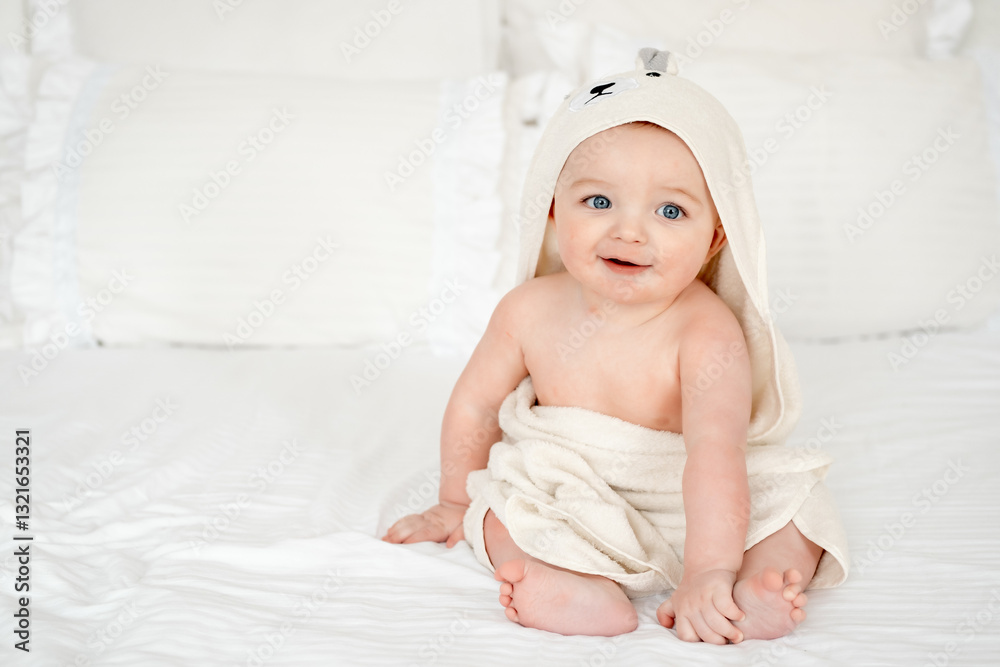 a baby in a towel on a white bed at home, a small boy child after bathing in the bathtub, a place and space for text, the concept of child hygiene a baby in a towel on a white bed at home, a small boy child after bathing in the bathtub, a place and space for text, the concept of child hygiene