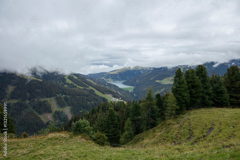 Fototapeta premium Scenic view of Gerlos and Konigsleiten mountains in Austria with cloudy skies and lush green valleys