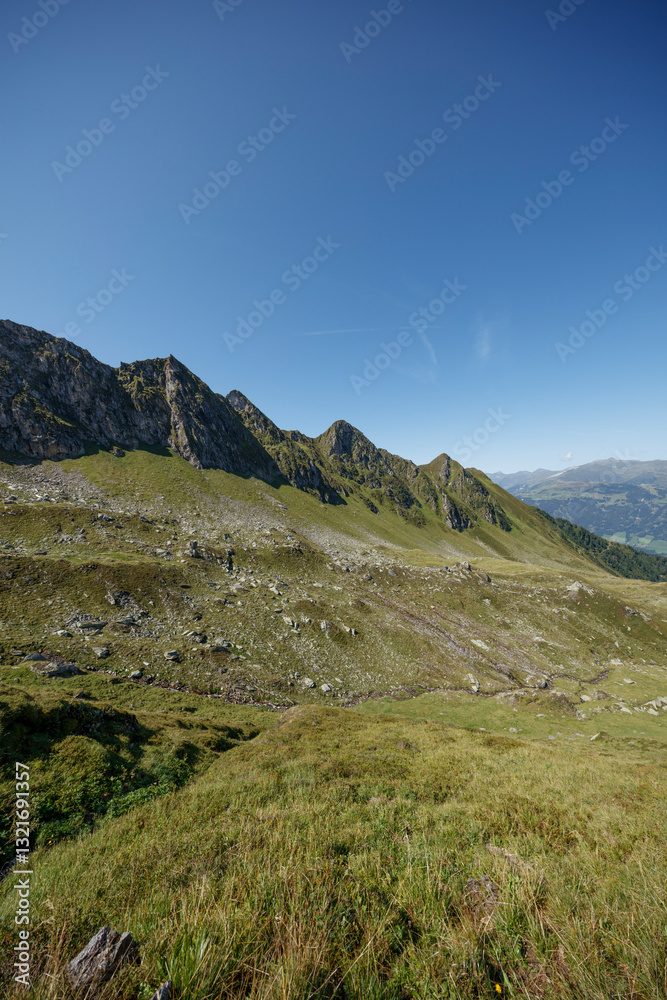 Exploring the breathtaking Ahorn mountain range in Mayrhofen, Austria under a clear blue sky Exploring the breathtaking Ahorn mountain range in Mayrhofen, Austria under a clear blue sky