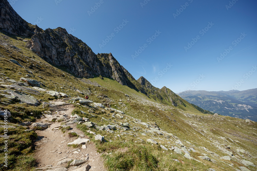 Majestic mountain trail in Mayrhofen, Austria near Ahorn under a clear blue sky Majestic mountain trail in Mayrhofen, Austria near Ahorn under a clear blue sky