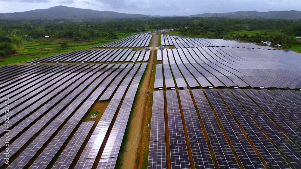 Large solar farm with photovoltaic panels in a green rural landscape Large solar farm with photovoltaic panels in a green rural landscape