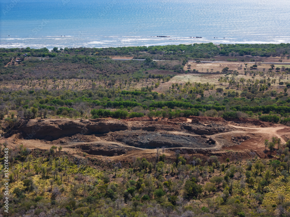 Fototapeta premium Landscape showing coastal area and excavation site near body of water