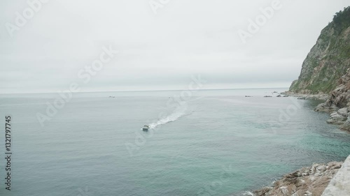 Sakhalin, Aniva lighthouse. Water, mountains and birds all around. Cloudy weather