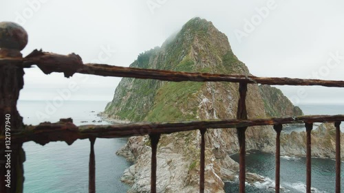 Sakhalin, Aniva lighthouse. Water, mountains and birds all around. Cloudy weather