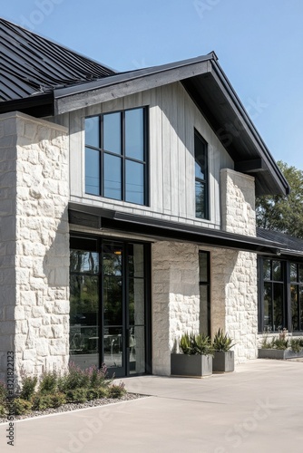 Modern architectural design of a bright stone building with large windows surrounded by greenery in a serene outdoor setting