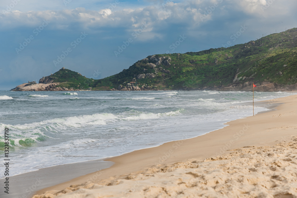 Ocean beach with sun light before an oncoming storm. Mole beach in Florianopolis Ocean beach with sun light before an oncoming storm. Mole beach in Florianopolis