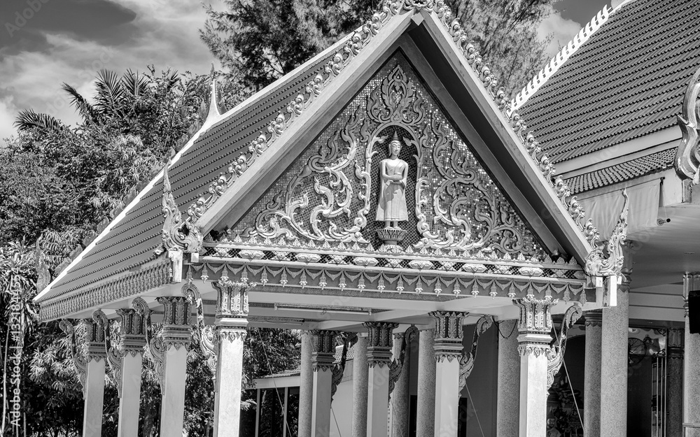 Traditional Buddhist temple Wat Choeng Thale in Phuket surrounded by lush greenery