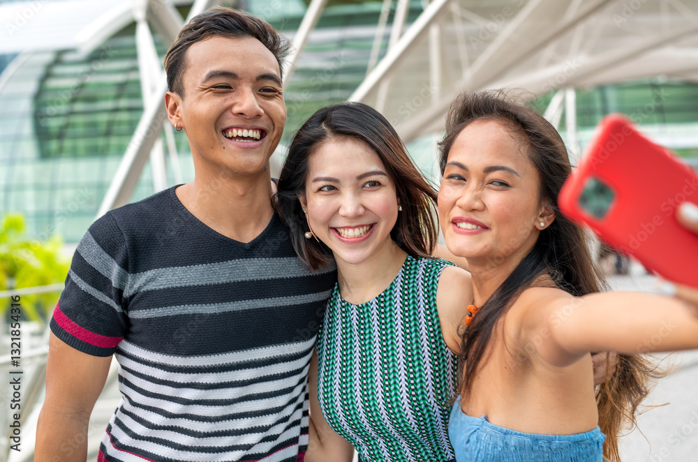 Three young asian friends spending outdoor time together in the city