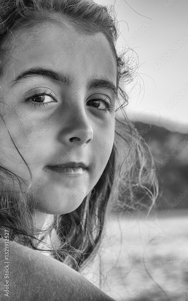 Young girl feeling the sea breeze while sailing on a boat in paradise