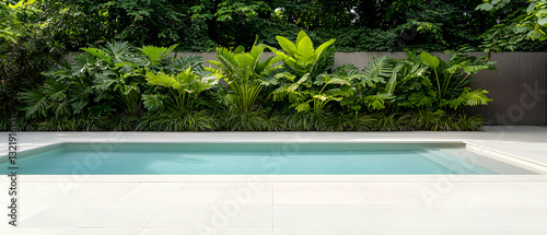 Inviting Turquoise Swimming Pool With Lush Green Tropical Plants and Modern Wood Fence in a Serene Backyard Oasis