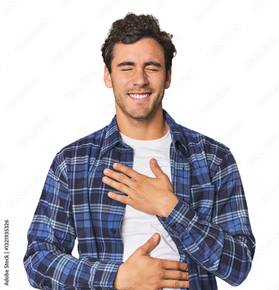 Young Hispanic man in studio laughs happily and has fun keeping hands on stomach. Young Hispanic man in studio laughs happily and has fun keeping hands on stomach.