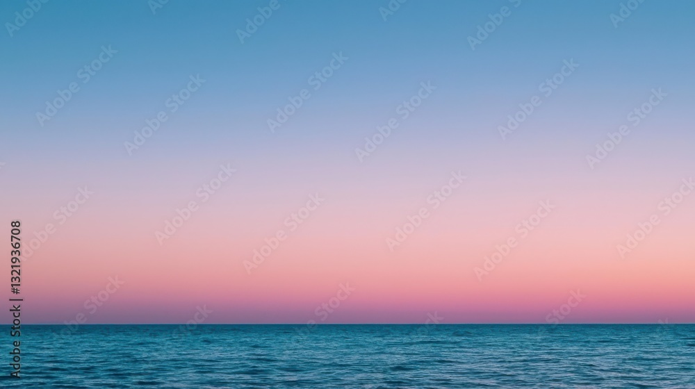 Fototapeta premium Dramatic Pink and Blue Sky Above Calm Ocean Creating Tranquil Atmosphere
