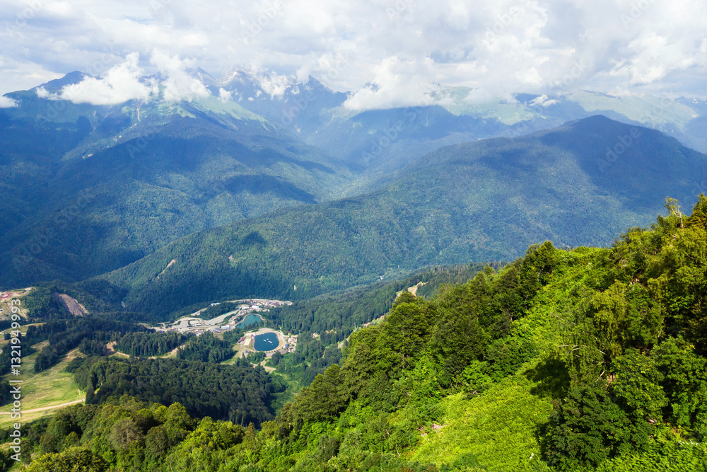 Mountain landscape Rosa Khutor resort near Sochi, Russia, and cloudy sky in serene nature setting.