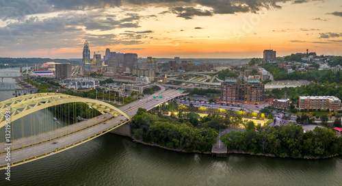 Slika na platnu Cincinnati, Ohio with driving cars on Daniel Carter Beard Bridge highway near illuminated skyscraper buildings in downtown district in USA