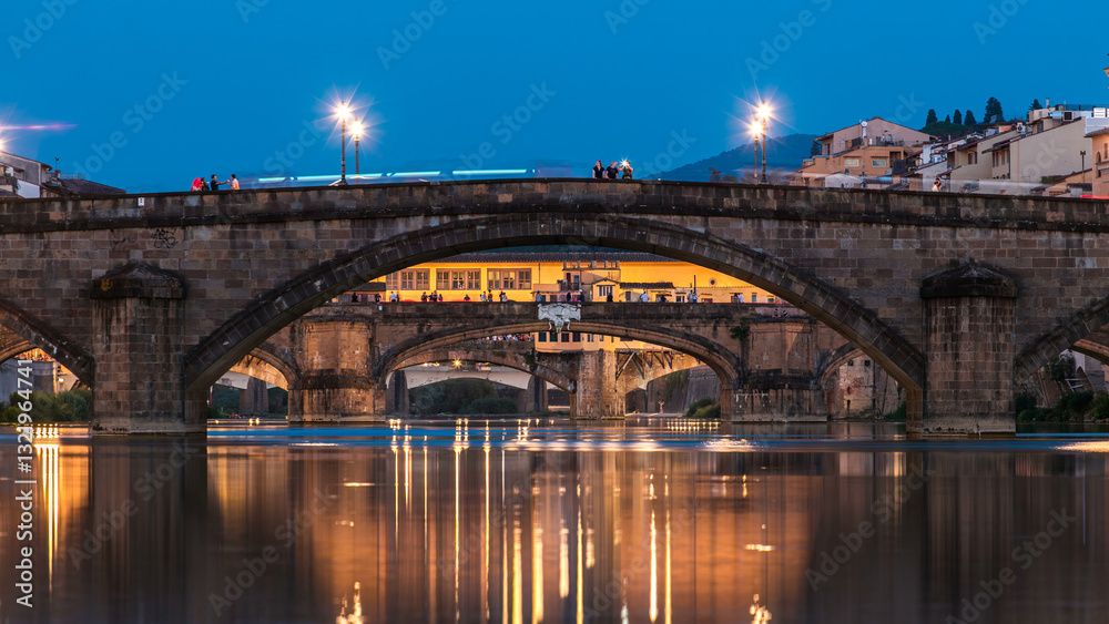 Naklejka premium Ponte Alla Carraia and Santa Trinita Holy Trinity Bridge day to night timelapse over River Arno in Florence