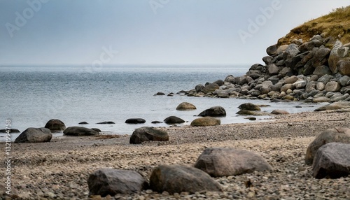 Gentle cliffs and a calm shoreline stretch beneath a hazy horizon, evoking a sense of tranquil coastal beauty.
