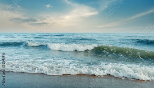 A wide, sunlit beach with gentle waves rolling under a pale sky, conveying calm and minimal coastal beauty.