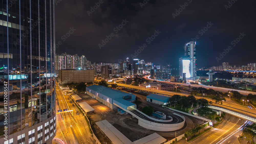Fototapeta premium Aerial view of busy traffic night in finance urban timelapse hyperlapse with panorama of city buildings, Hong Kong city
