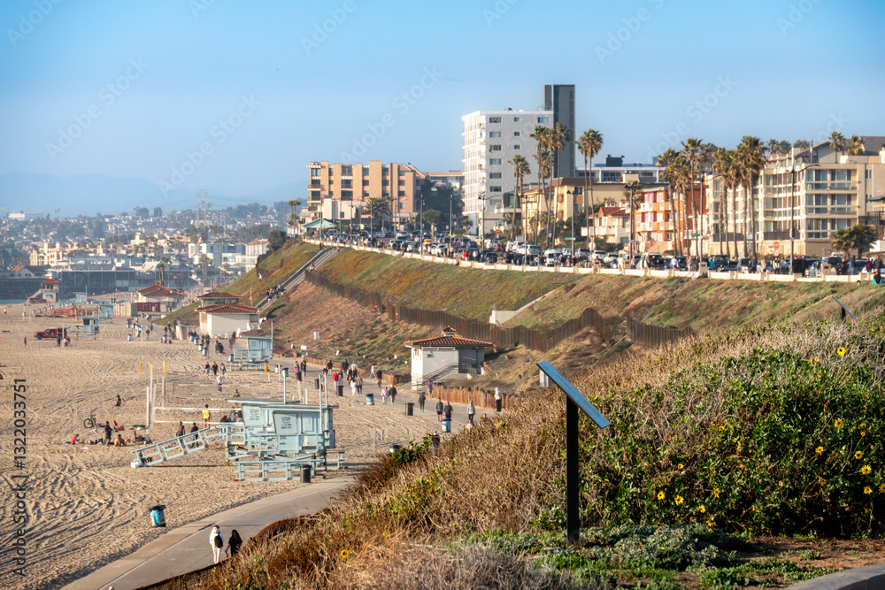 Some people out along the strand of Redondo Beach on a beautiful day with background of Esplanade