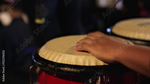 Close of man playing percussion instrument, conga, drum, atabaque in a numbers concert