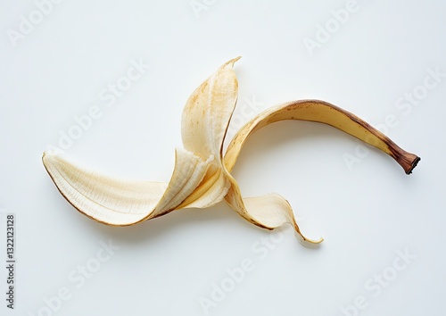 Dried banana peel, light tan color,  splayed open, isolated on a white background