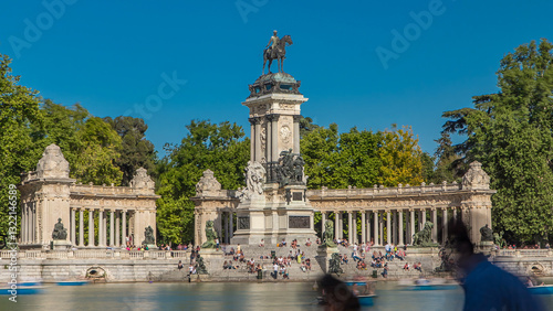 Tourists on boats at Monument to Alfonso XII timelapse hyperlapse in the Park of the Pleasant Retreat in Madrid, Spain